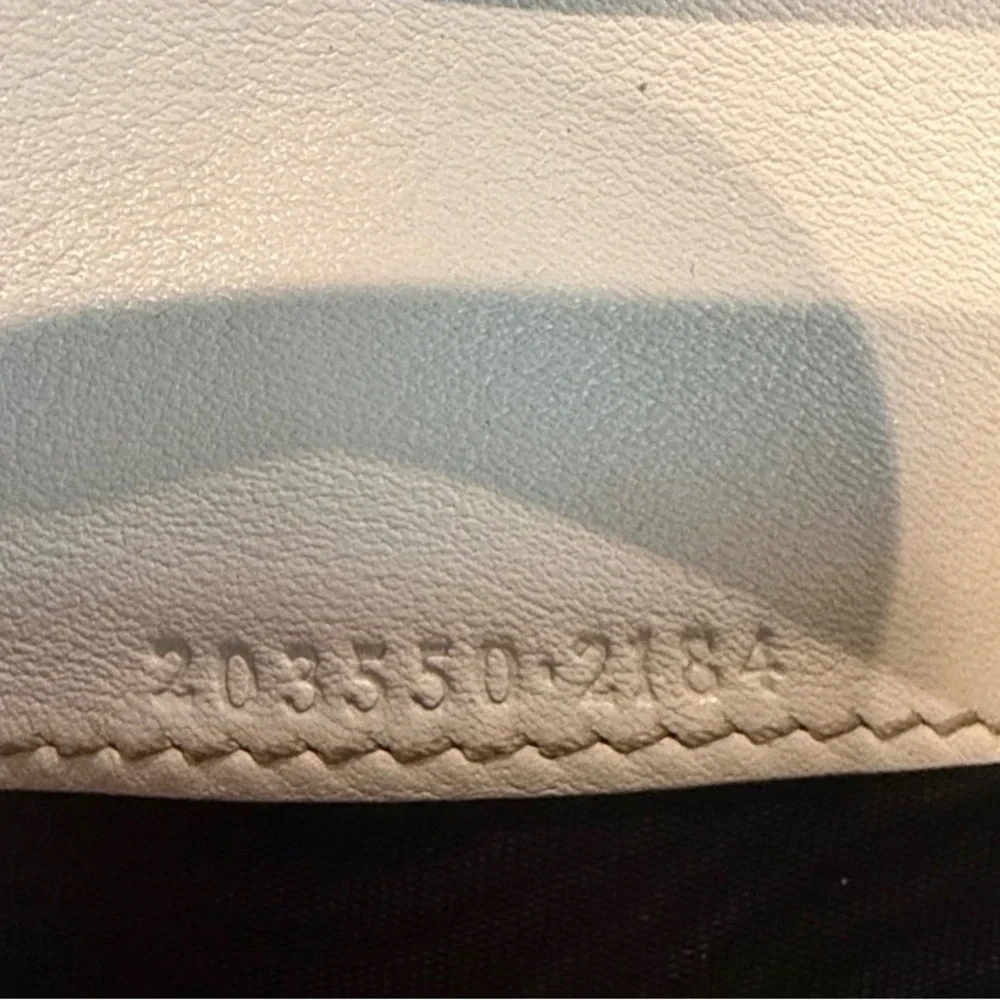 Gucci GG Canvas Long Wallet featuring white leather and heart-shaped closure